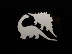 Transfer-Applikation zum Aufbügeln ca. 9 cm x 5,5 cm - Glow in the Dark - 2 Dinosaurier - weiß 